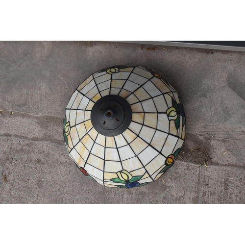 364 - A large Tiffany - style domed lampshade with floral decoration. 45cm diameter.