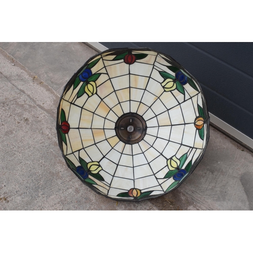 364 - A large Tiffany - style domed lampshade with floral decoration. 45cm diameter.