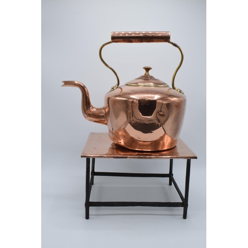 374 - A Victorian copper kettle with brass handle together with copper and metal large trivet (2). Combine... 