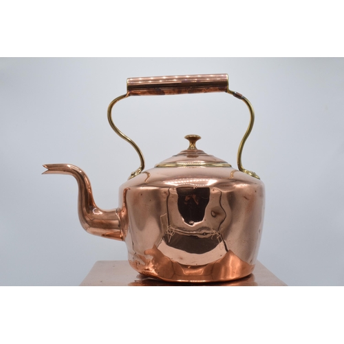 374 - A Victorian copper kettle with brass handle together with copper and metal large trivet (2). Combine... 