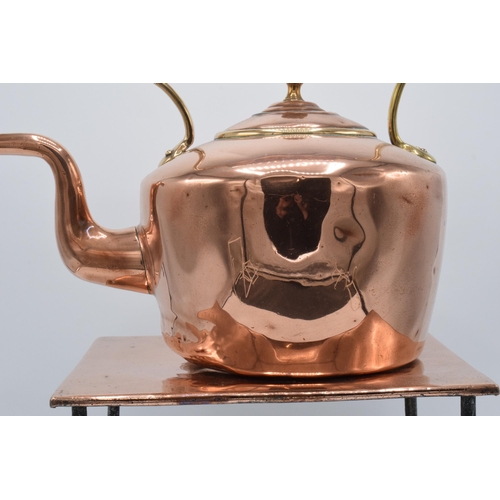 374 - A Victorian copper kettle with brass handle together with copper and metal large trivet (2). Combine... 