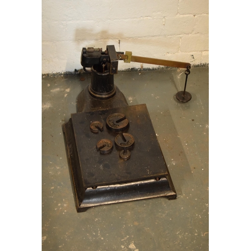 384 - A set of cast iron butcher's shop scales with weights.