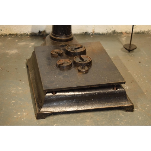 384 - A set of cast iron butcher's shop scales with weights.