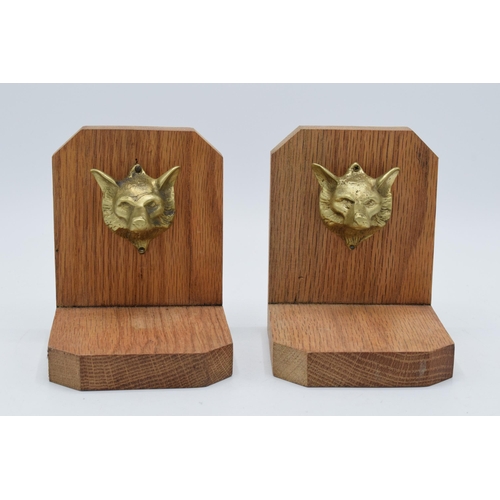 397 - A pair of wooden bookends with cast brass foxes head (2). 13cm tall.