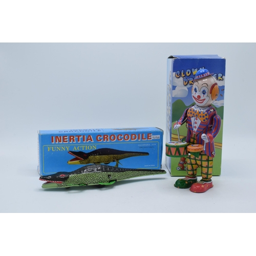 398 - A vintage tin plate Inertia Crocodile with key and box together with a tin-plate Clown Drummer (2).