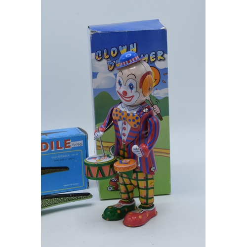 398 - A vintage tin plate Inertia Crocodile with key and box together with a tin-plate Clown Drummer (2).