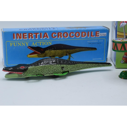 398 - A vintage tin plate Inertia Crocodile with key and box together with a tin-plate Clown Drummer (2).