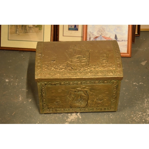 408 - A brass chest with repousse decoration and wooden linings with lion's head handles. 40cm wide.