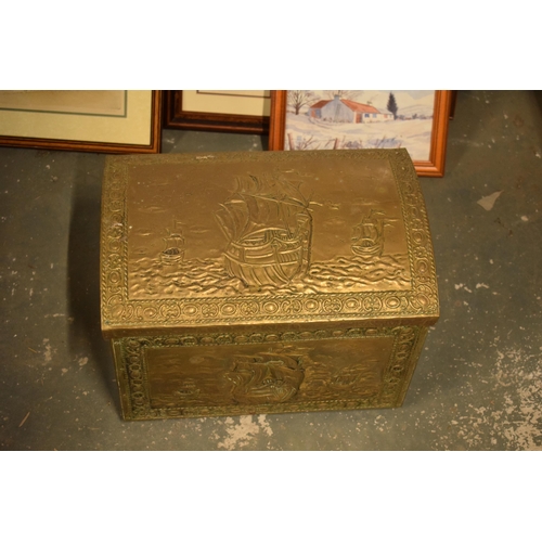 408 - A brass chest with repousse decoration and wooden linings with lion's head handles. 40cm wide.