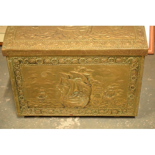 408 - A brass chest with repousse decoration and wooden linings with lion's head handles. 40cm wide.