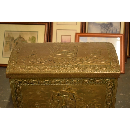 408 - A brass chest with repousse decoration and wooden linings with lion's head handles. 40cm wide.