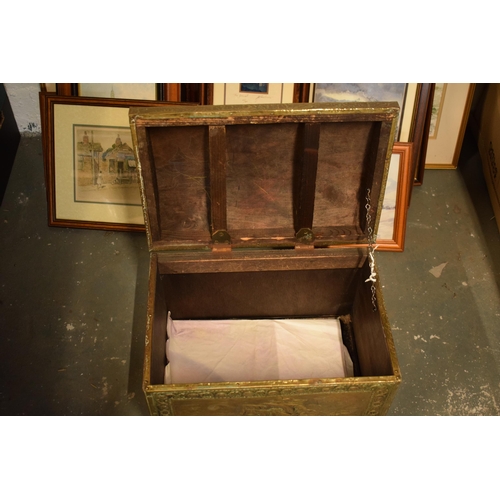 408 - A brass chest with repousse decoration and wooden linings with lion's head handles. 40cm wide.