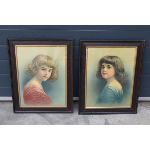 416 - A pair of early 20th century prints of young girls in wooden frames (2). 61 x 47cm inc frames.