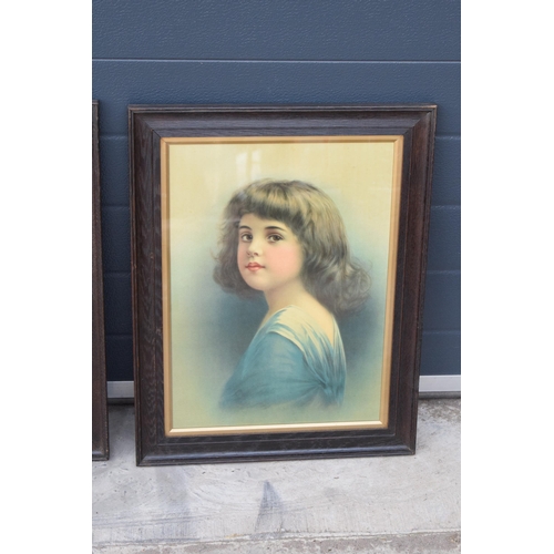 416 - A pair of early 20th century prints of young girls in wooden frames (2). 61 x 47cm inc frames.