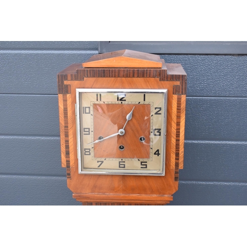 418 - An art deco oak cased granddaughter clock by Haller. 140cm tall. Untested.