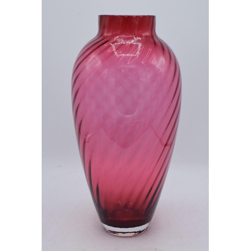 67 - A large vintage cranberry glass with swirling decoration, 35cm tall. In good condition with no obvio... 