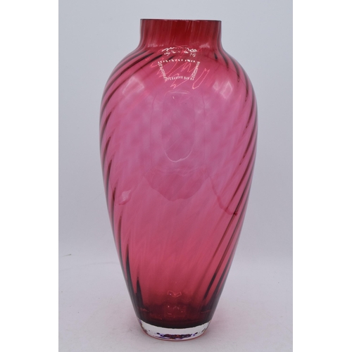 67 - A large vintage cranberry glass with swirling decoration, 35cm tall. In good condition with no obvio... 