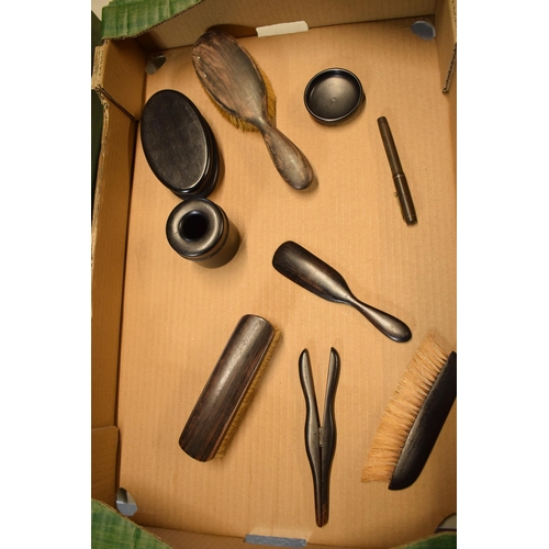 422 - A collection of ebonised wooden items to include brushes, pots and trinkets etc (Qty).