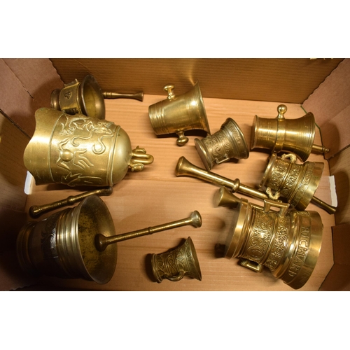 425 - A good collection of cast brass mortar and pestles of varying ages together with an oriental brass i... 