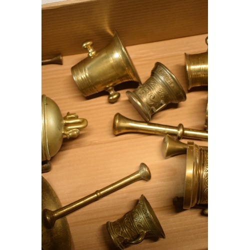 425 - A good collection of cast brass mortar and pestles of varying ages together with an oriental brass i... 