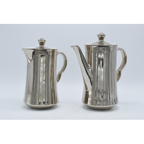 60A - A pair of Royal Worcester silver pottery tea and coffee pots (2). In good condition with no obvious ... 