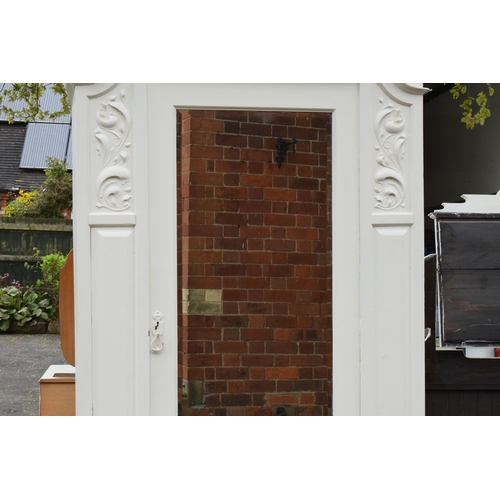 428 - A painted white wooden Edwardian wardrobe with carved decoration and mirrored door. 115 x 54 x 227cm... 