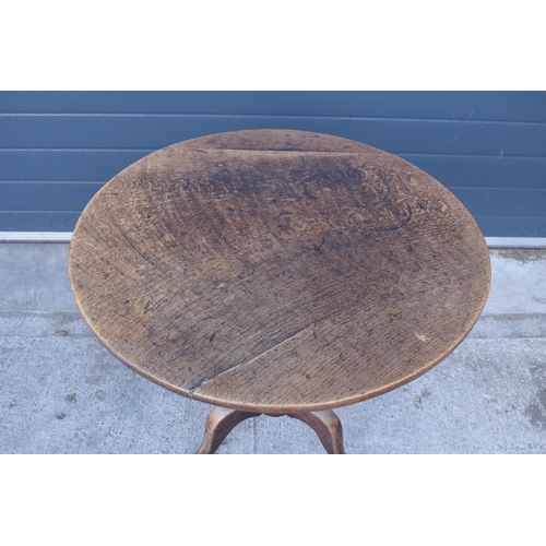 429 - A 19th century oak tilt-top tripod table with circular top on a turned column. 70cm tall, 75cm wide.... 