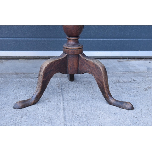 429 - A 19th century oak tilt-top tripod table with circular top on a turned column. 70cm tall, 75cm wide.... 