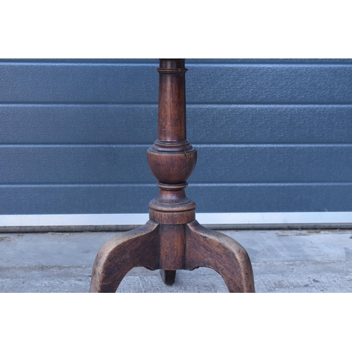 429 - A 19th century oak tilt-top tripod table with circular top on a turned column. 70cm tall, 75cm wide.... 