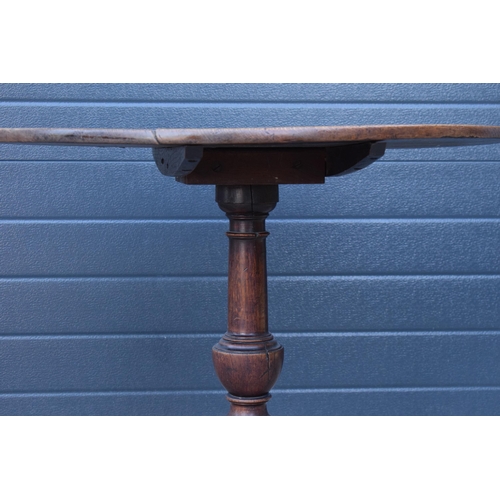 429 - A 19th century oak tilt-top tripod table with circular top on a turned column. 70cm tall, 75cm wide.... 