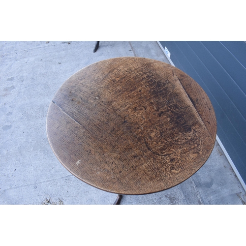 429 - A 19th century oak tilt-top tripod table with circular top on a turned column. 70cm tall, 75cm wide.... 