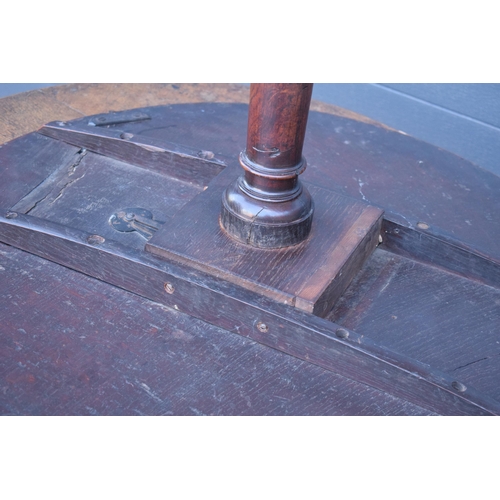 429 - A 19th century oak tilt-top tripod table with circular top on a turned column. 70cm tall, 75cm wide.... 