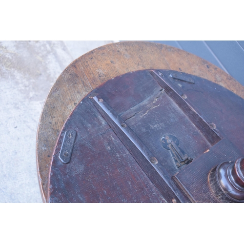 429 - A 19th century oak tilt-top tripod table with circular top on a turned column. 70cm tall, 75cm wide.... 