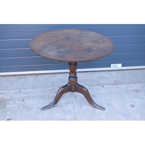 430 - A 19th century oak tripod table with circular top on a column. 96 x 53 x 86cm tall. In good conditio... 