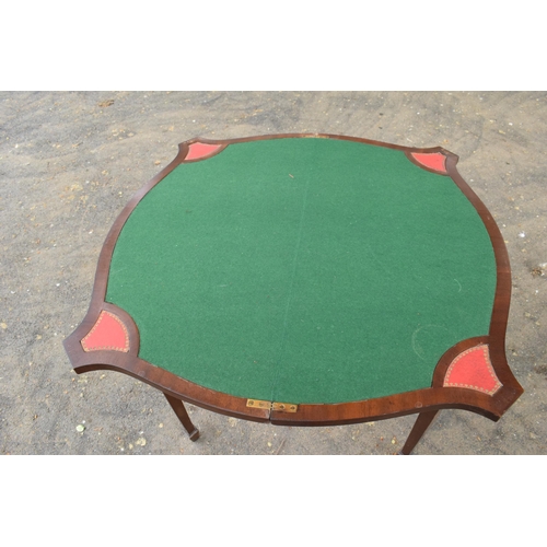 433 - A reproduction folding card table with green felt table and red leather insets. 80cm tall. 88cm when... 