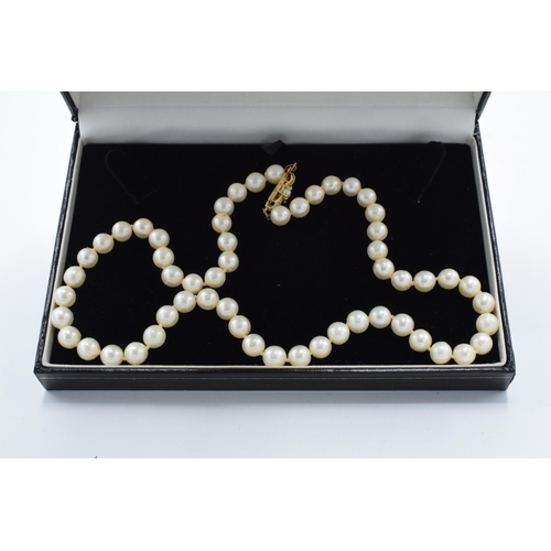 496 - A cased set of single-string cultured pearls with a 9ct gold clasp. Approx 50cm long.