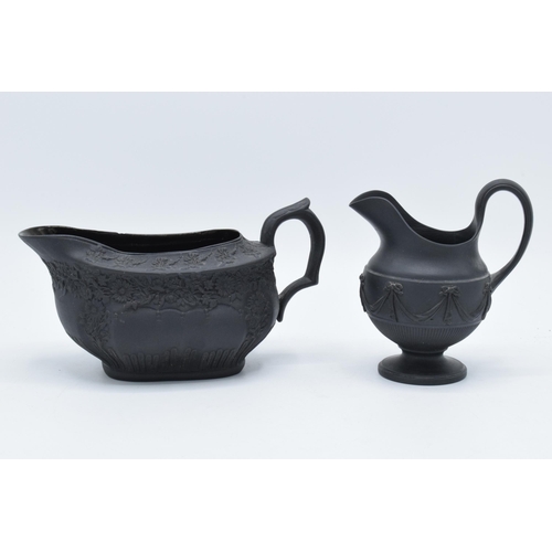 100 - A pair of early 19th century basalt milk jugs, circa 1800 to include one of globular form on a pedes... 