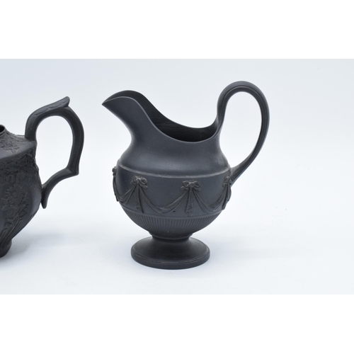 100 - A pair of early 19th century basalt milk jugs, circa 1800 to include one of globular form on a pedes... 