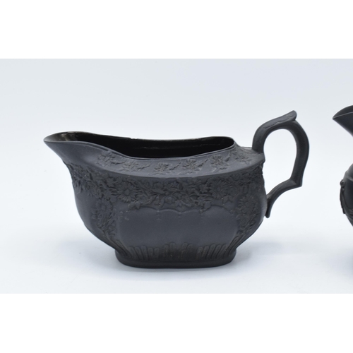 100 - A pair of early 19th century basalt milk jugs, circa 1800 to include one of globular form on a pedes... 