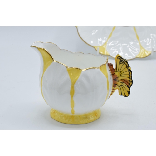 109 - A collection of Aynsley yellow leaf moulded tea ware to include 5 tea cups with butterfly finial han... 