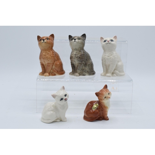 129 - A collection of Beswick cats and kittens to include 1886 in ginger, grey and white together with 143... 