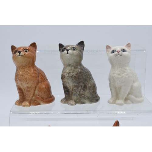 129 - A collection of Beswick cats and kittens to include 1886 in ginger, grey and white together with 143... 