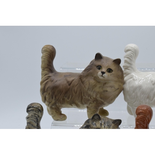 131 - A collection of Beswick 1898 cats in a grey colourway together with white, ginger and matte grey exa... 