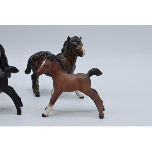 135 - A collection of small Beswick foals and horses to include Shetland pony, another Shetland, matte bla... 