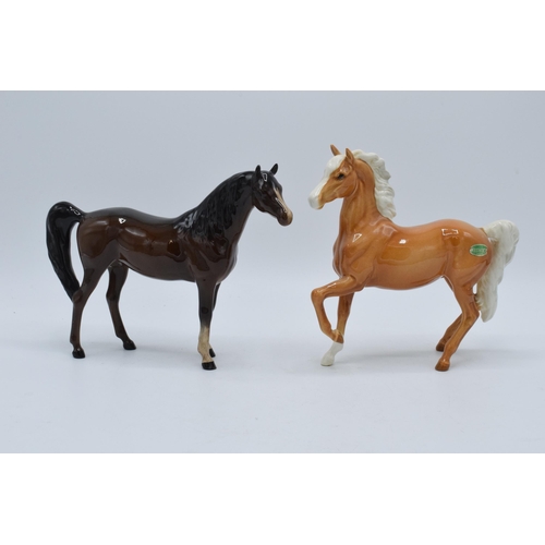 140 - A pair of Beswick horses to include palomino prancing Arab 1261 and brown Arab Xayal 1265 (2).