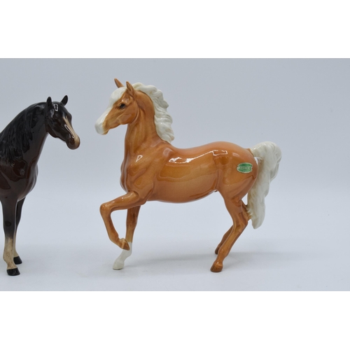 140 - A pair of Beswick horses to include palomino prancing Arab 1261 and brown Arab Xayal 1265 (2).