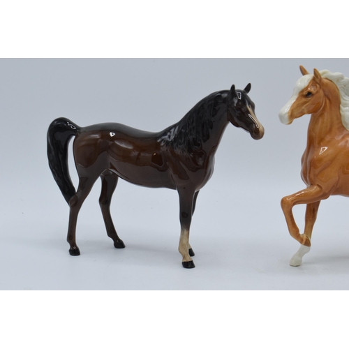 140 - A pair of Beswick horses to include palomino prancing Arab 1261 and brown Arab Xayal 1265 (2).