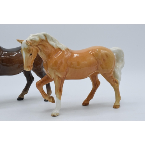 141 - A pair of Beswick stocky jogging mare horses in a brown colourway and a palomino colourway (2).