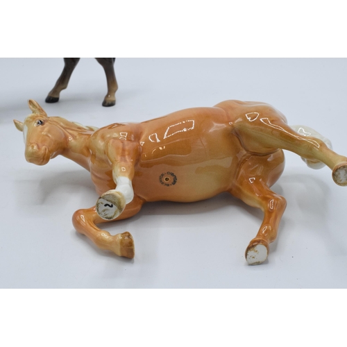 141 - A pair of Beswick stocky jogging mare horses in a brown colourway and a palomino colourway (2).