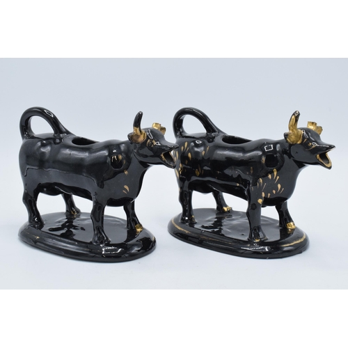 198B - A pair of earthenware 20th century Staffordshire-style cow creamers in Jackfield manner (2) (horns d... 